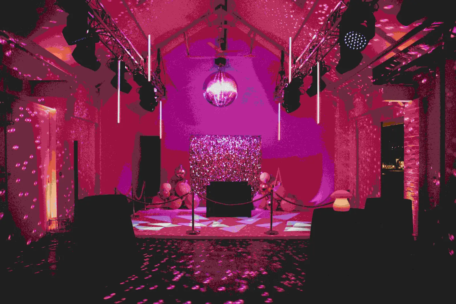 fivefourstudios pink-lit event space with disco ball